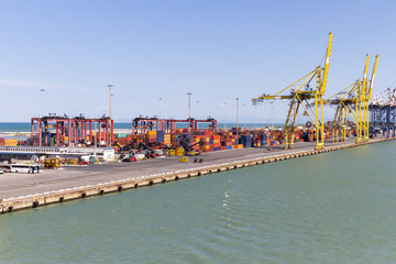 Fototapeta na wymiar Harbor infrastructure with cranes and containers