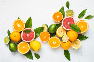Fresh citrus fruit assortment on white.