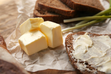 Delicious toast and butter on table, closeup