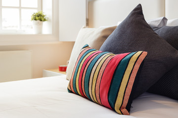 Colorful pillows on a bright bedroom