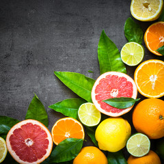 Fresh citrus fruit assortment on black.