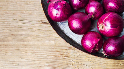 Purple onions on the metal plate