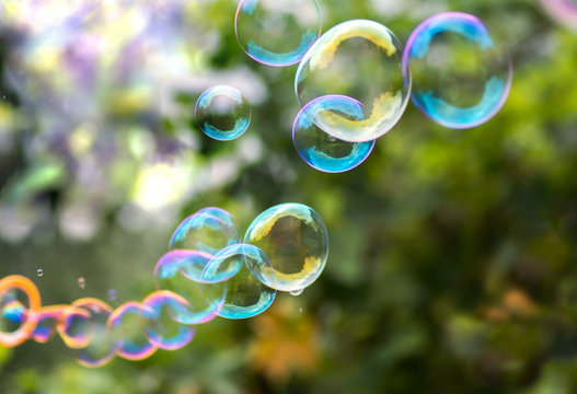 Large beautiful multi-colored soap bubbles in the garden