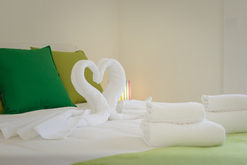 Towels in the shape of a Swan in a bright room