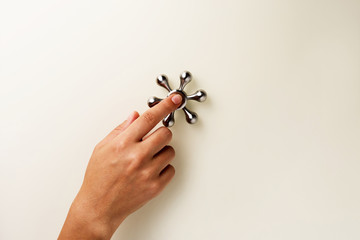 Woman's hand with spinner on glass table