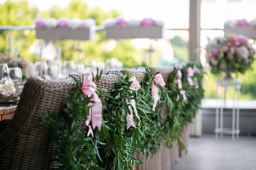 wooden chairs with a laurel wreath on terrace restaurant