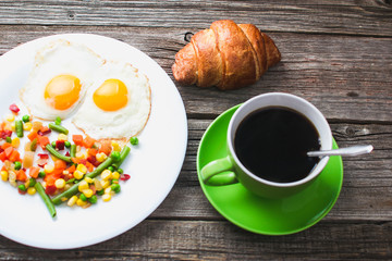 Coffee in a green mug on wooden surface