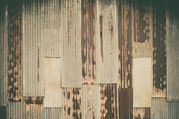 Old rusty corrugated tin zinc metal wall in vintage tone.
