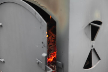 burning wood in a big BBQ