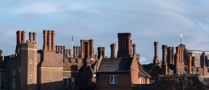 Chimneys and parapets on Tudor architecture red brick building skyline