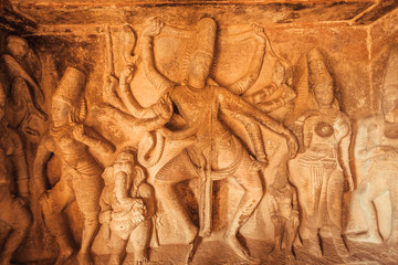 Great dancer Shiva Lord with many hands. Old relief with example of the Ancient Indian architecture in Aihole, India
