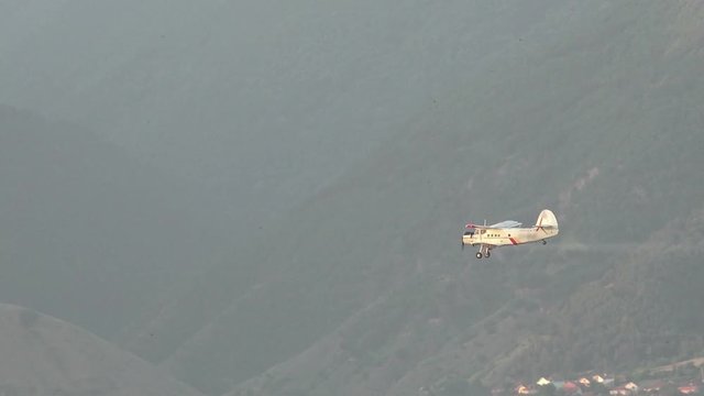 A crop dusting plane working over a field