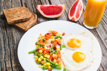 Breakfast on the wooden background from chicken breast