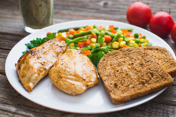Breakfast on the wooden background from chicken breast