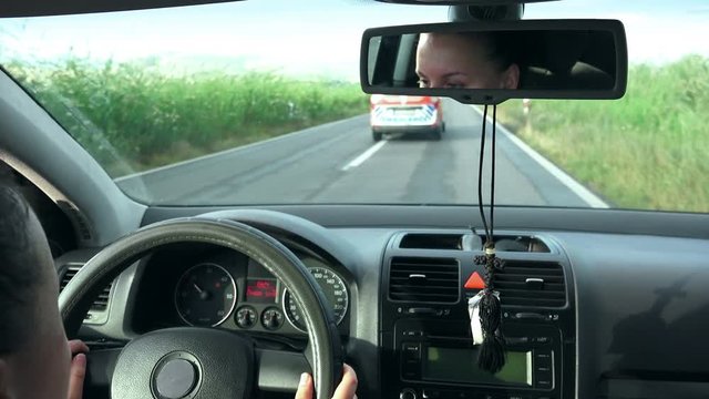 Emergency services Ambulance car overtaking girl car driver 
