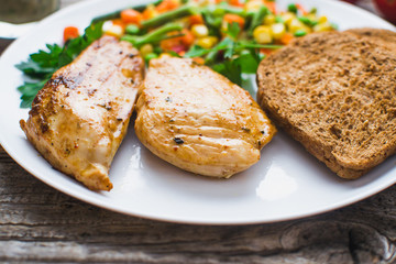 Breakfast on the wooden background from chicken breast