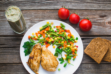 Breakfast on the wooden background from chicken breast