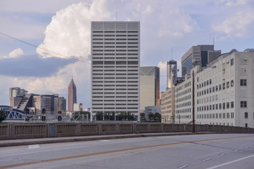 Downtown Buildings In Atlanta With Blue Sky Clouds From A Brdige With Many Windows