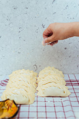 Female Hands adding a bit of Flour from above