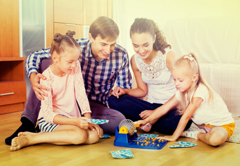 Fototapeta premium Parents and daughters with toy lotto
