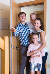 family standing at doorway