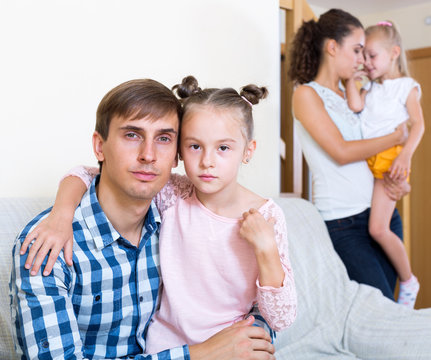 Sad spouses with two daughters