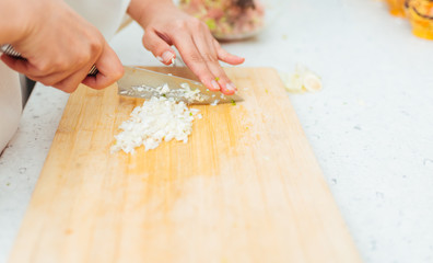 Female Hands Cutting Onion