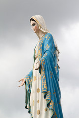 Virgin mary statue on overcast sky at Catholic church, Chantaburi, Thailand.