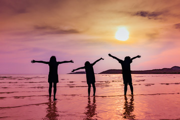 Silhouette group of kids enjoy and play on the beach of Thailand, Concept of happiness and freedom