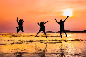 Silhouette group of kids enjoy and play on the beach of Thailand, Concept of happiness and freedom