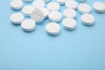 Health care concept. Pills on blue background