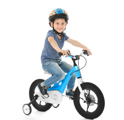 Cute little boy riding bicycle on white background