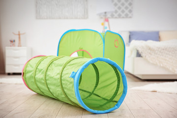 Toy tunnel and tent in baby room