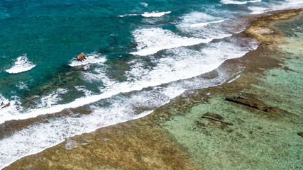 Shipwrecks in clear, shallow water on a tropical coral reef