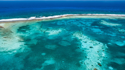 A huge, fringing tropical coral reef system
