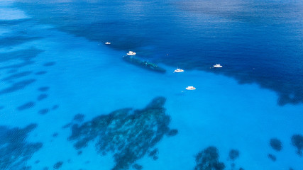 Dive boats over the wreck of the USS Kittiwake and coral reef