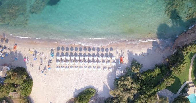 Video from above, aerial view of a turquoise sea and a white beach in Sardinia, Italy.