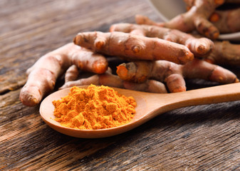 Turmeric powder on wooden background