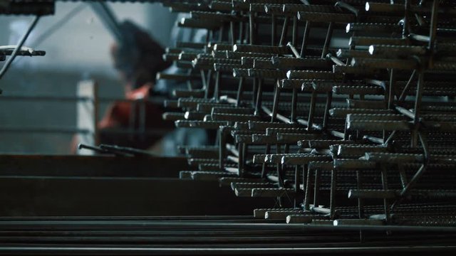 Welder welds the parts of the structure. Manufacture of reinforced concrete structures. Welding is an integral part of the technological process. Close up