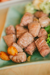 Beef steak small piece juicy wet oil meat medium rare with spices and grilled vegetables tasty served ready to eat.