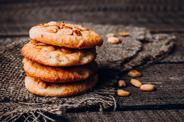Close up Stack of Oatmeal cookies with peanuts on dark rustic wooden background table. Close up, copy space