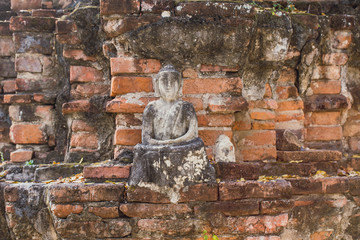 brick ancient buddha is broken. old Buddha meditation. Buddha statue has destroy happy smile face.