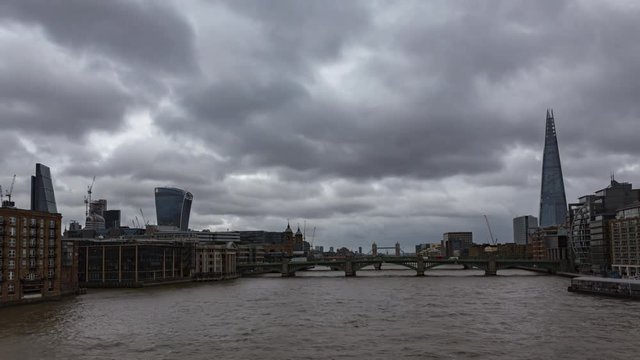 City of London view Time-Lapse with the Thames and skyscrapers. 
Southwark Bridge, Train Bridge and the Tower Bridge with the highest building in London and Europe.
Cloudy, rainy weather.