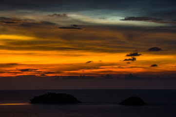 Fototapeta premium Beautiful blazing sunset landscape at black sea and orange sky above it. Amazing summer sunset view on the beach.