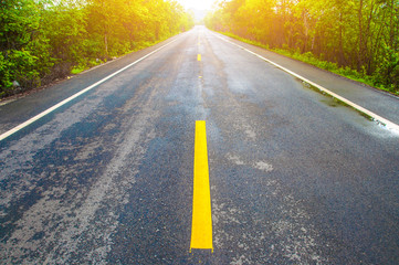 Close up road view of yellow center lines