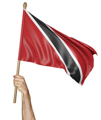 Hand proudly waving the national flag of Trinidad and Tobago isolated on a white background, 3D rendering