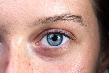 Intense blu eye of young woman looking at the camera