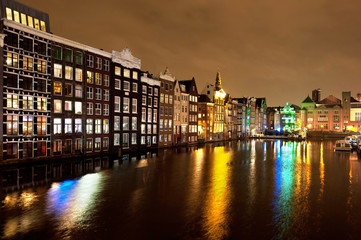 Canals with lights on water in Amsterdam at night