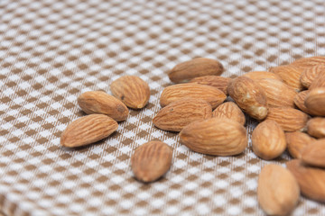 Burlap sack with almonds spilling out