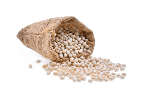 small white beans, haricot, white pea, white kidney or cannellini purgatorio beans in a bag sackcloth isolated on white background